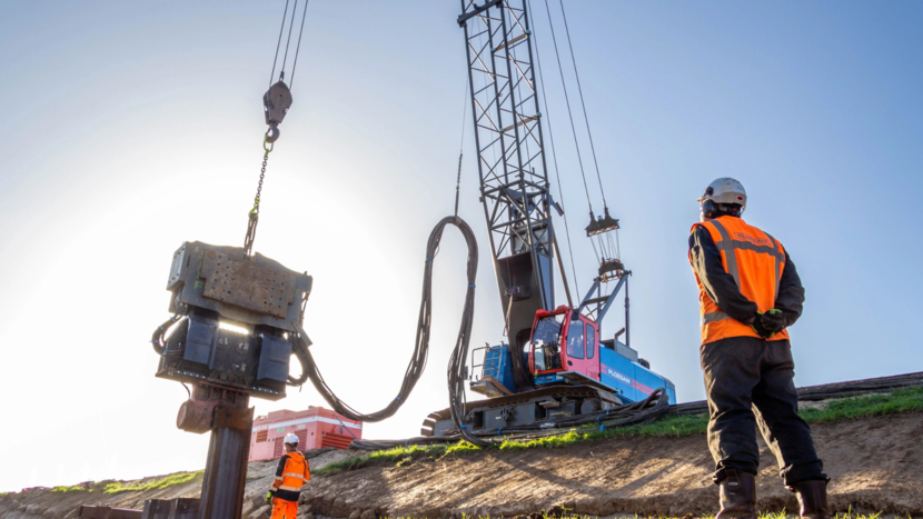 Bouwmedewerker kijkt naar elektrische kraan